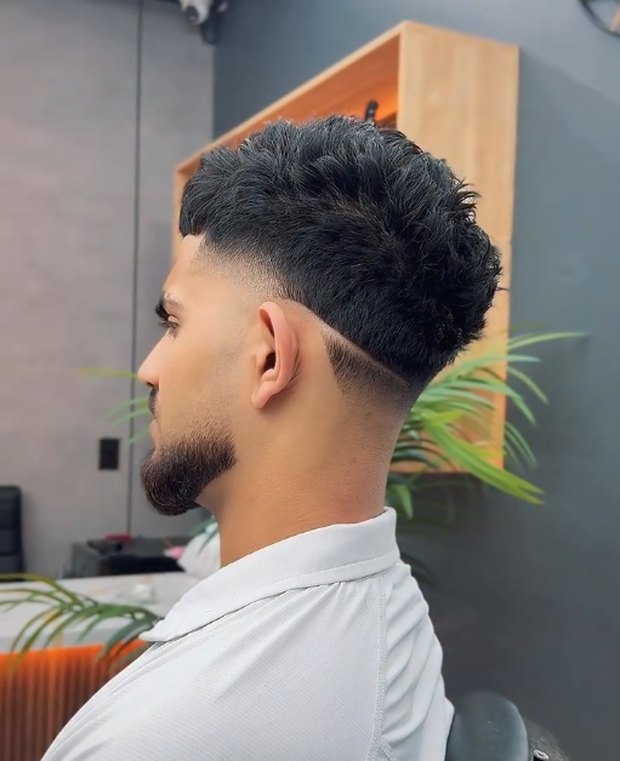 Textured crop with a low taper fade, side profile