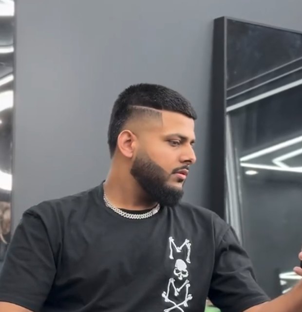 Skin fade with a hard part, front view