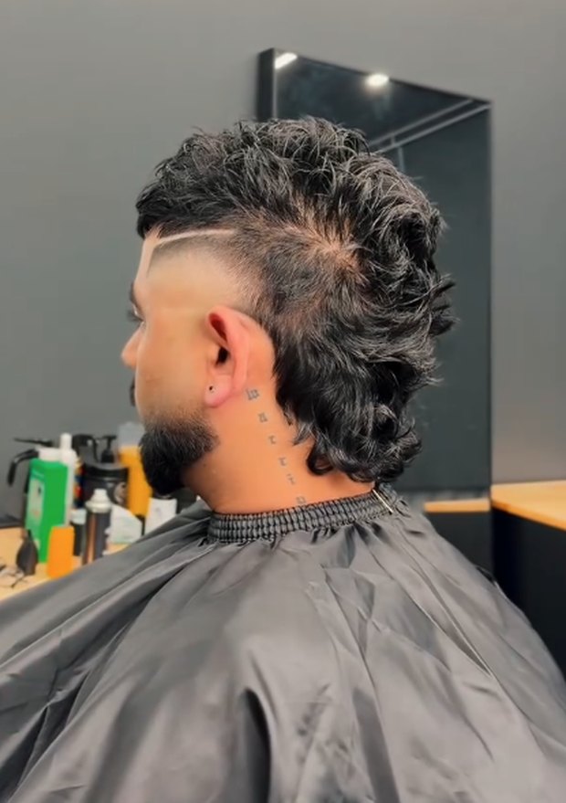 Wavy mullet with a line-up, rear three-quarter