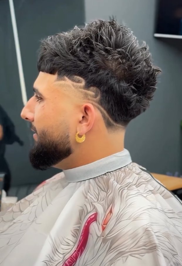 Textured mullet with a hard part and razor line