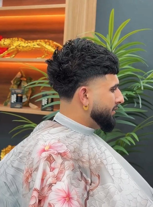 Curly crop with a clean taper, side profile